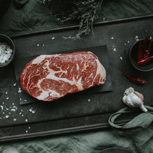 Load image into Gallery viewer, rib eye steak on iron platter