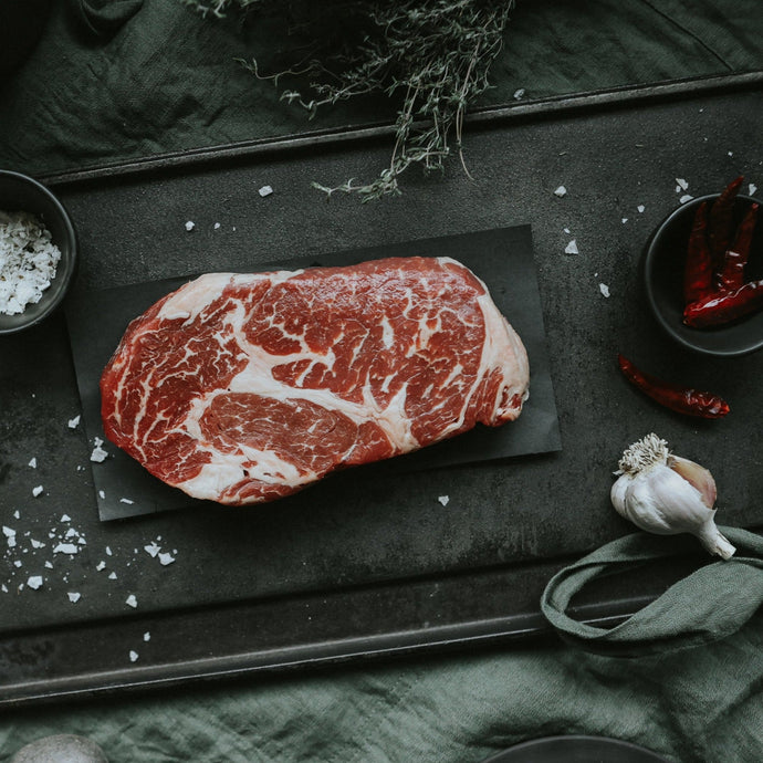 rib eye steak on iron platter