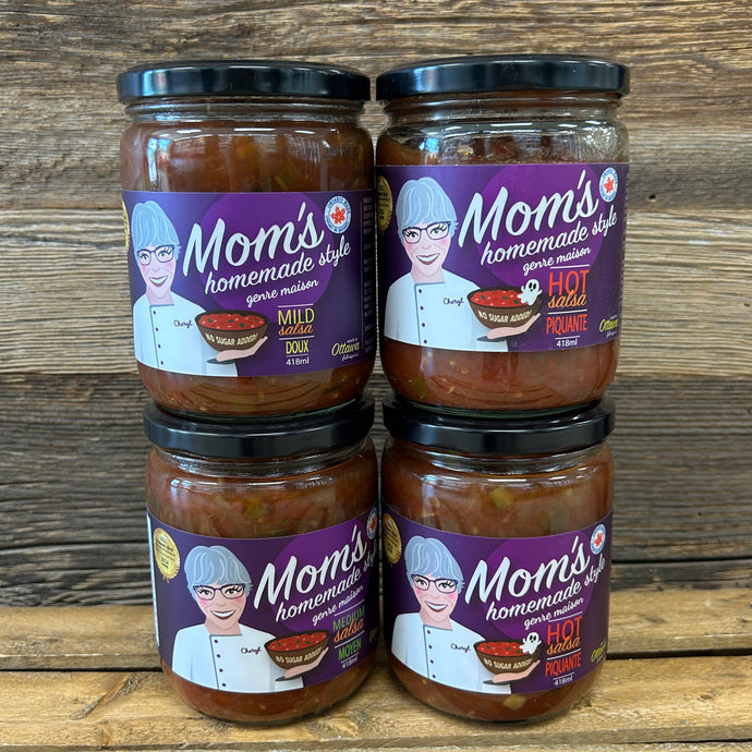 Four jars of Mom's homemade salsa on a wooden surface