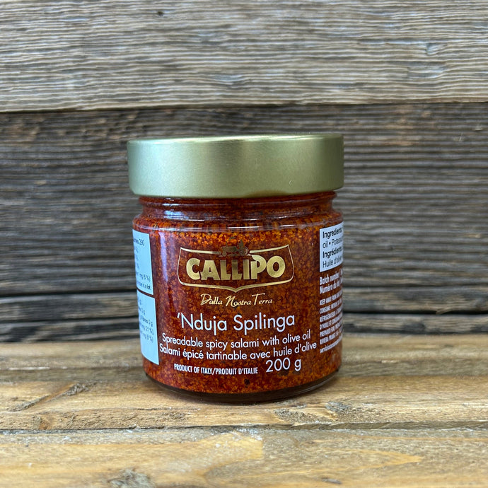 Small jar of Nduja on a wooden surface