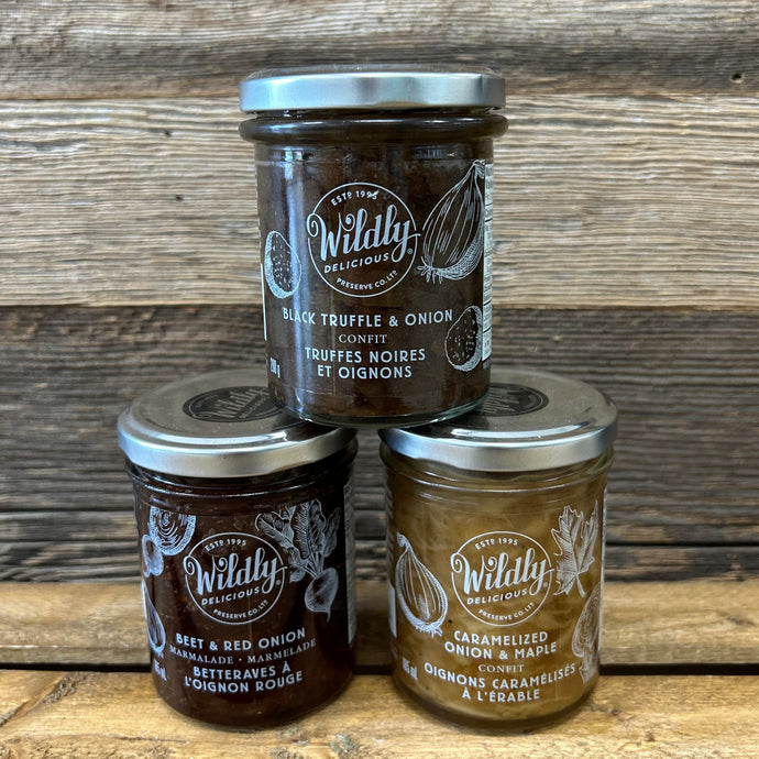 Three jars of Wildly Delicious confits on a wooden surface