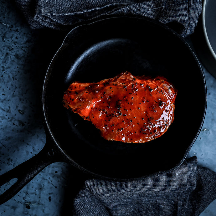 Marinated pork chop with cast iron pan. Cooked with barbecue sauce.