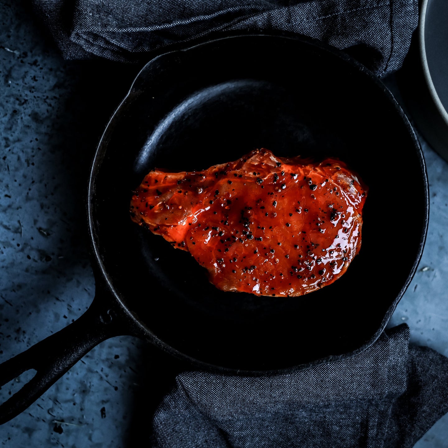 Marinated pork chop with cast iron pan. Cooked with barbecue sauce.