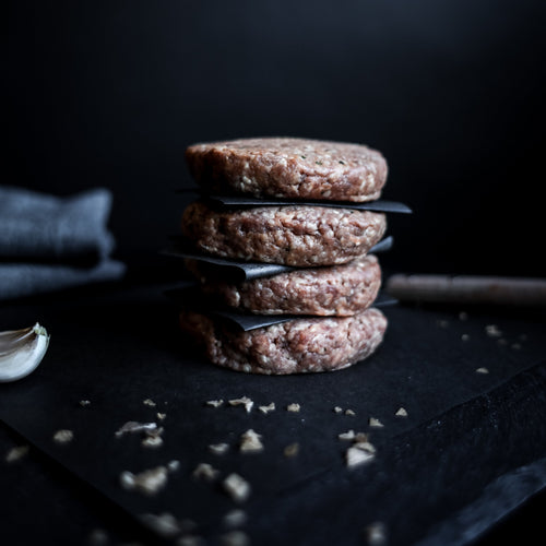 stack of four beef hamburgers