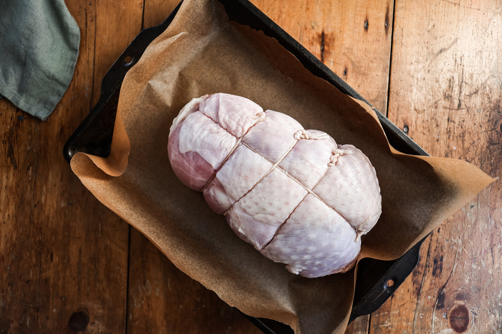 Fresh hormone and antibiotic-free skin-on turkey breast, ready for the oven (uncooked)